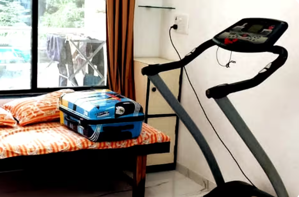 Bedroom at AG House with single bed and treadmill near window