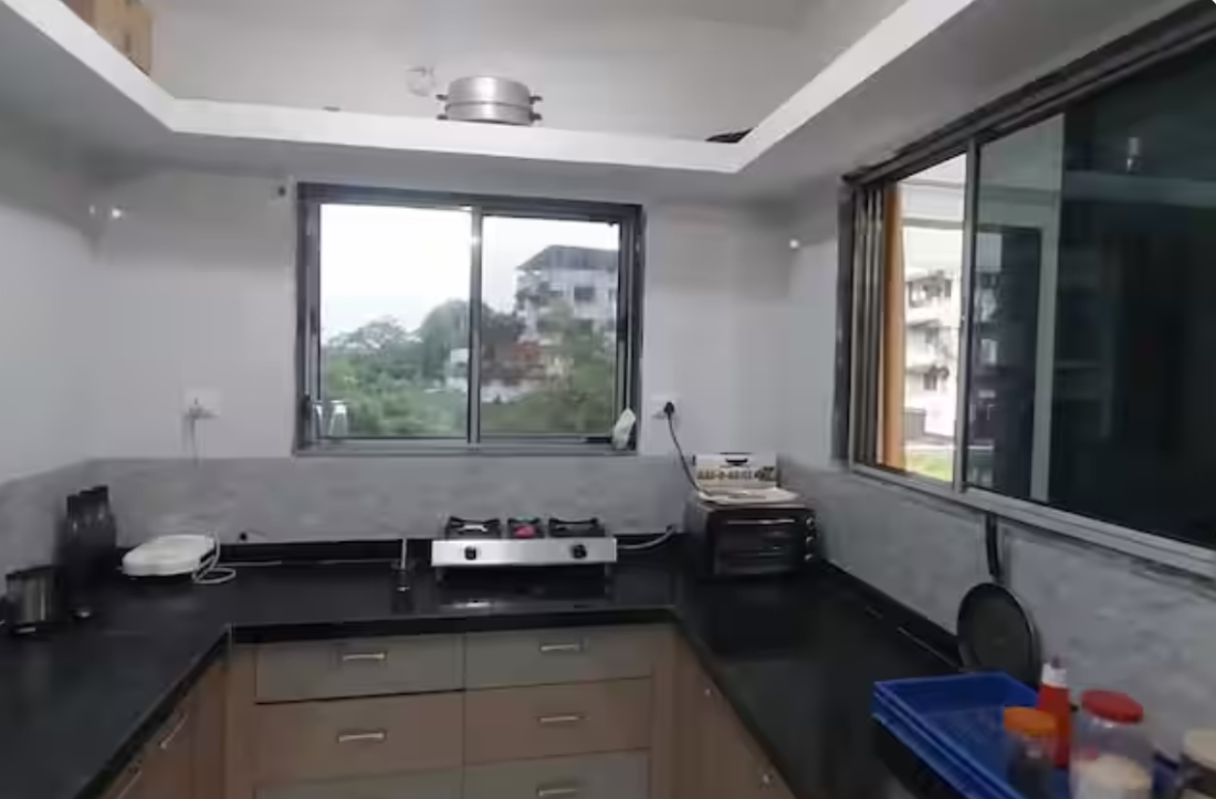 Modular kitchen with gas stove and counter at AG House in Daman
